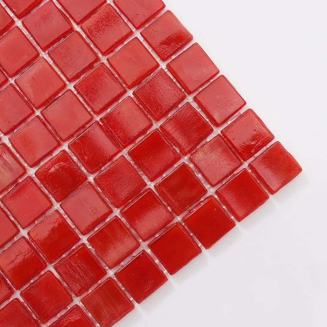 Corner detail of cherry red square glass mosaic tile with glossy surface