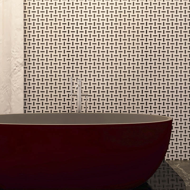 Close up of basketweave wall tile with bathtub faucet in a modern bathroom