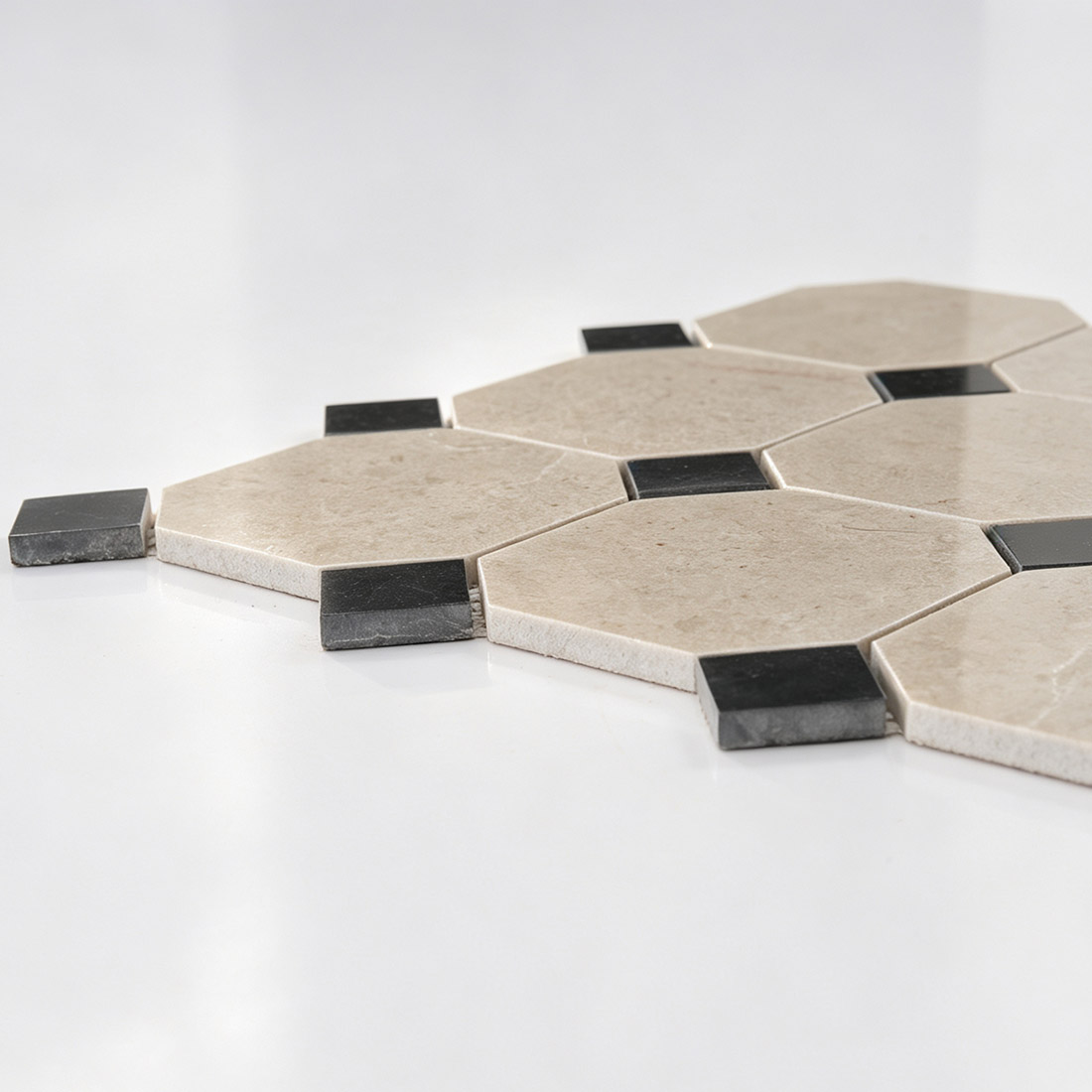 Close-up showing the side thickness of cream black marble tile.