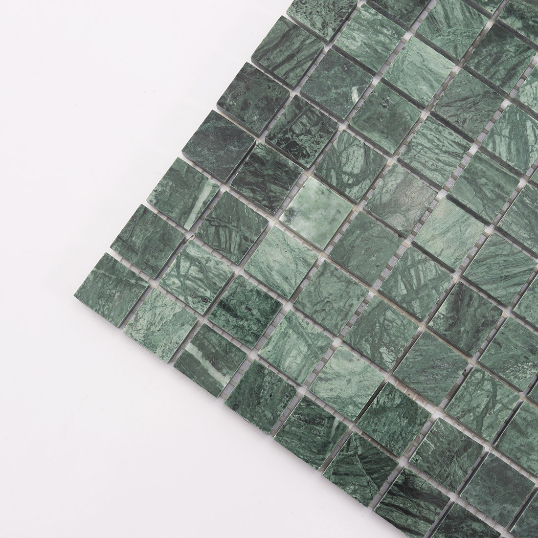 Close up of green square marble mosaic tile sheet with varied stone tones