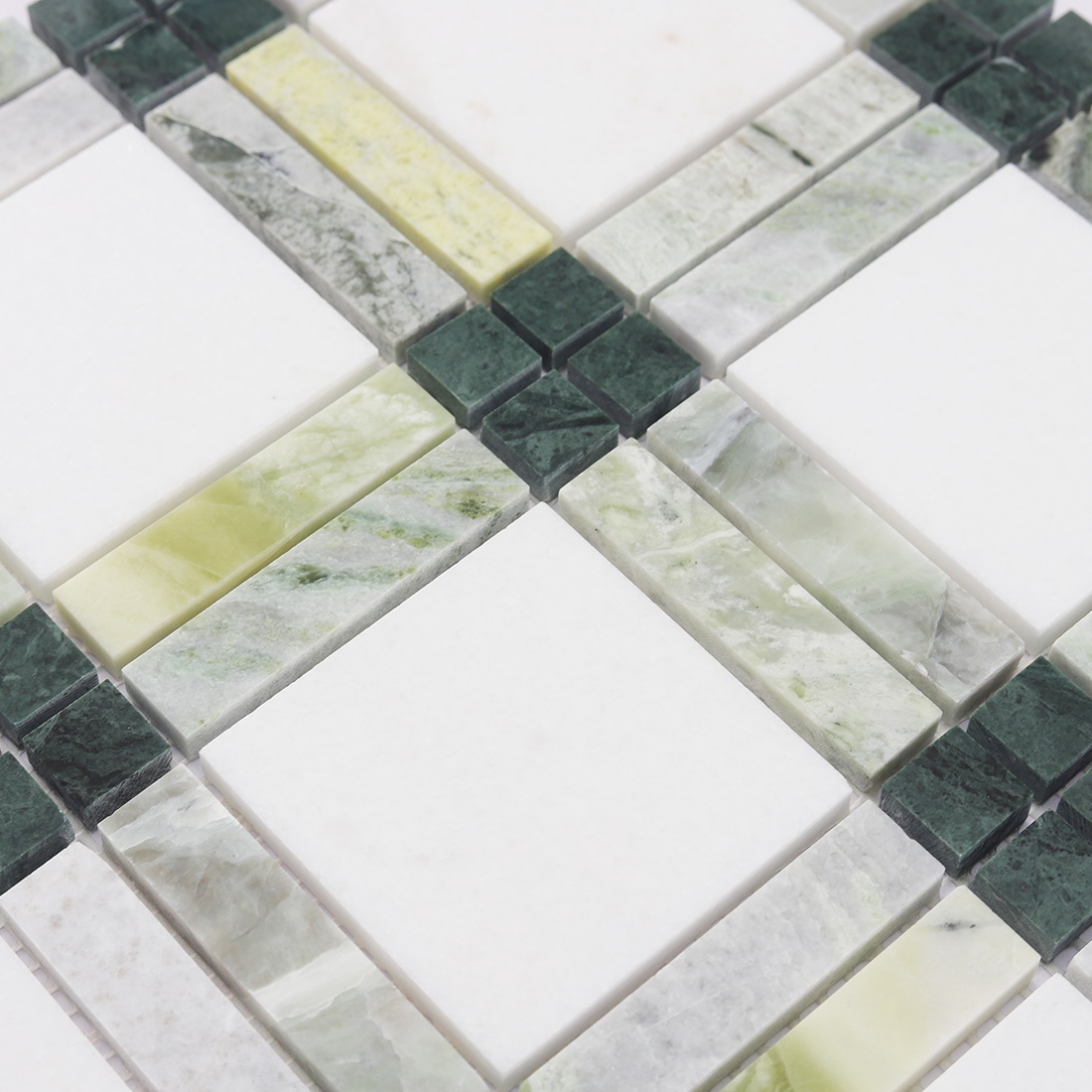 Close up of green and white marble geometric tile with polished stone texture