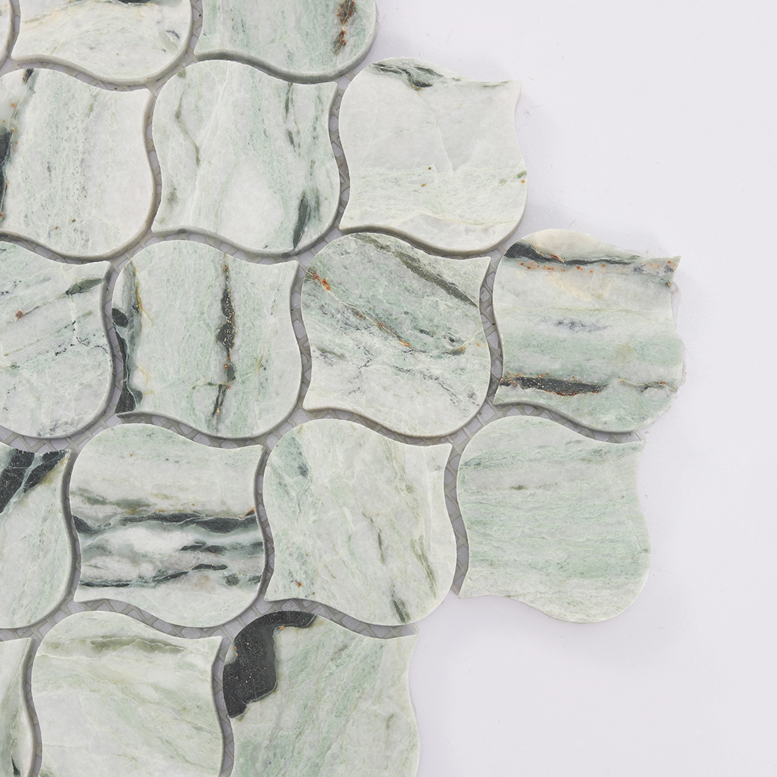 Close up of light green lantern marble mosaic tile with gray and black veins