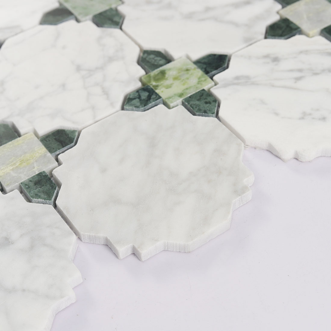 White octagon marble tile close up showing soft gray veining and raised edges