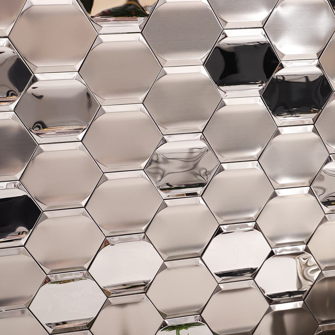 Close-up of silver brushed and mirror hexagon stainless steel mosaic wall tile