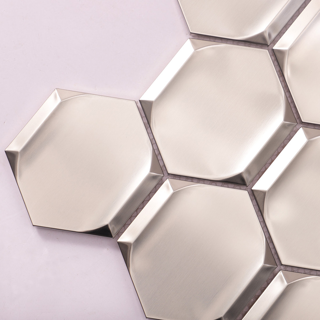 Close-up of silver brushed beveled hexagon stainless steel mosaic tile