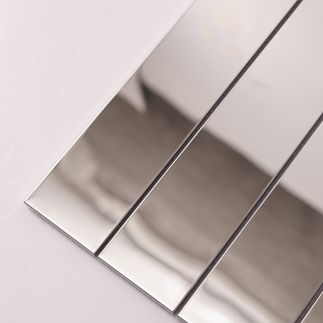 Diagonal close up of reflective silver mirror linear metal strips.