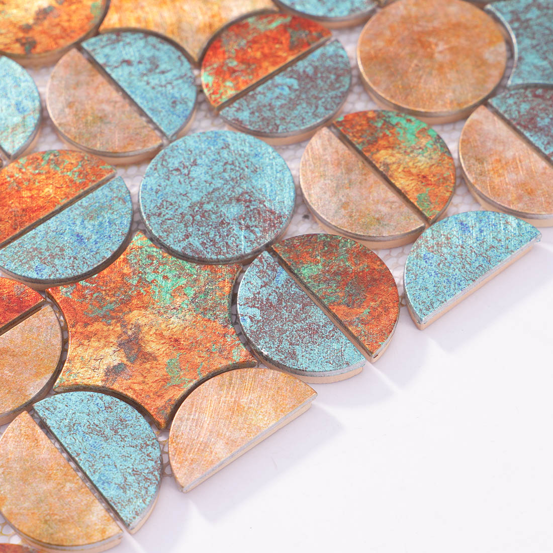 Angle shot of copper verdigris round mosaic tile showing metallic edge