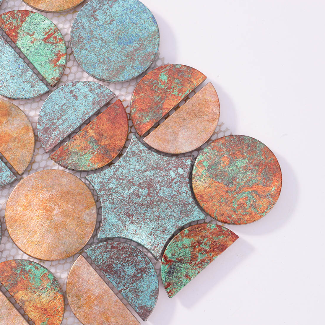 Close-up detail of copper verdigris round aluminum tile with star accent