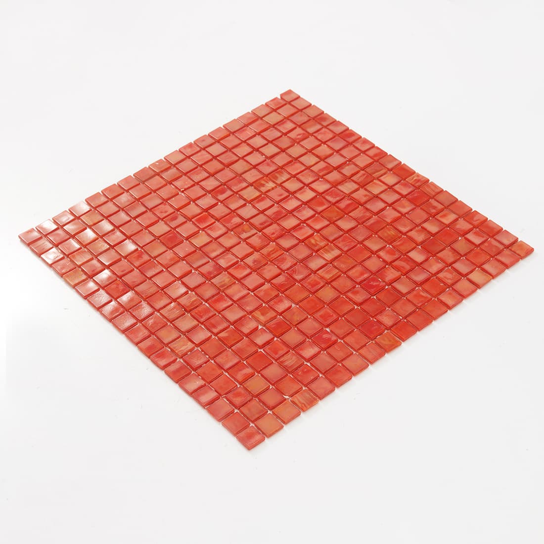 Angled view of coral red square glass mosaic tile sheet