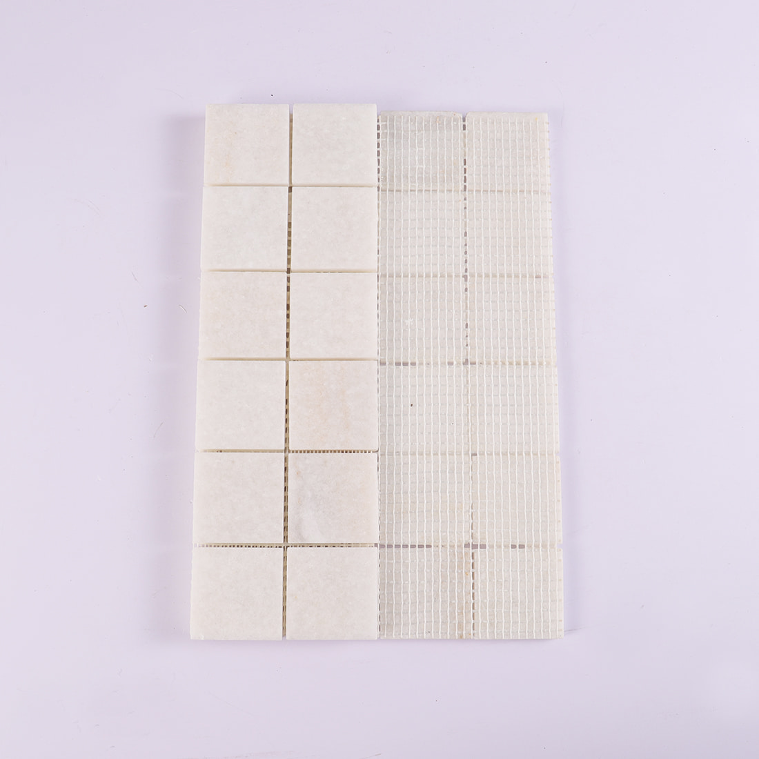 Back view of cream square marble mosaic tile with mesh backing