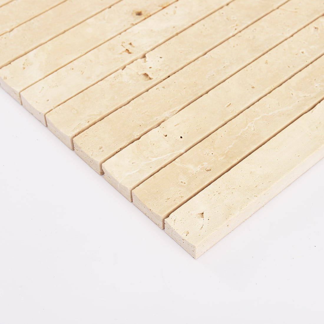 Close view of cream travertine fluted strip mosaic tile sheet