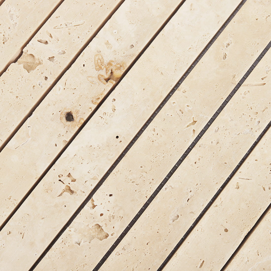 Surface detail of cream travertine fluted strip mosaic tile