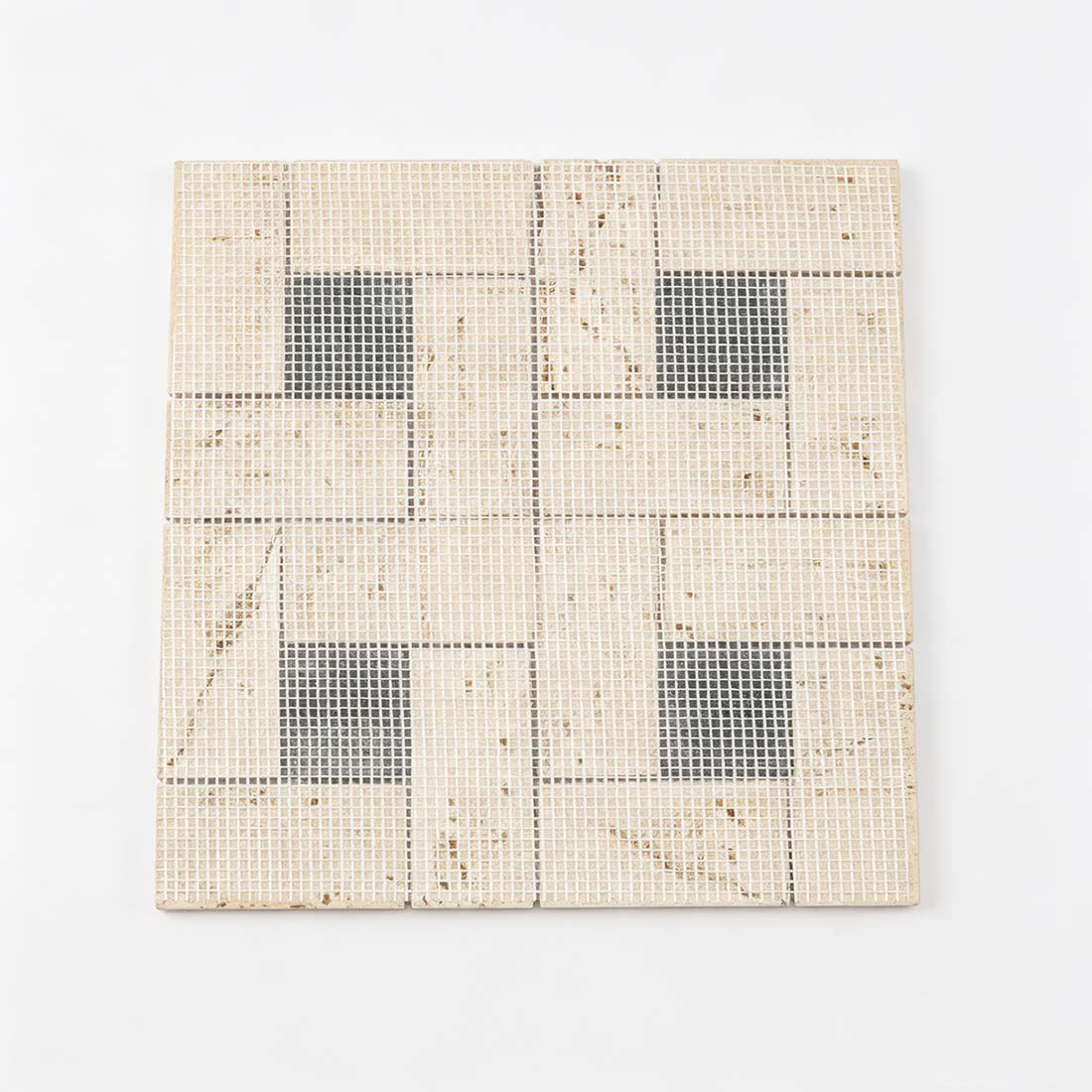 Reverse side of cream travertine mosaic tile sheet showing the mesh-mounted backing