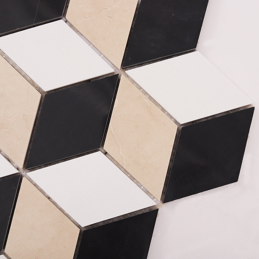 Close up of  cube mosaic tiles showing black white and beige marble faces