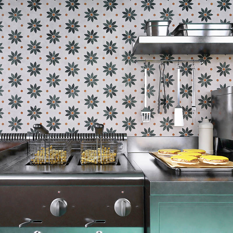 Daisy geometric tile backsplash above a commercial fryer and prep counter