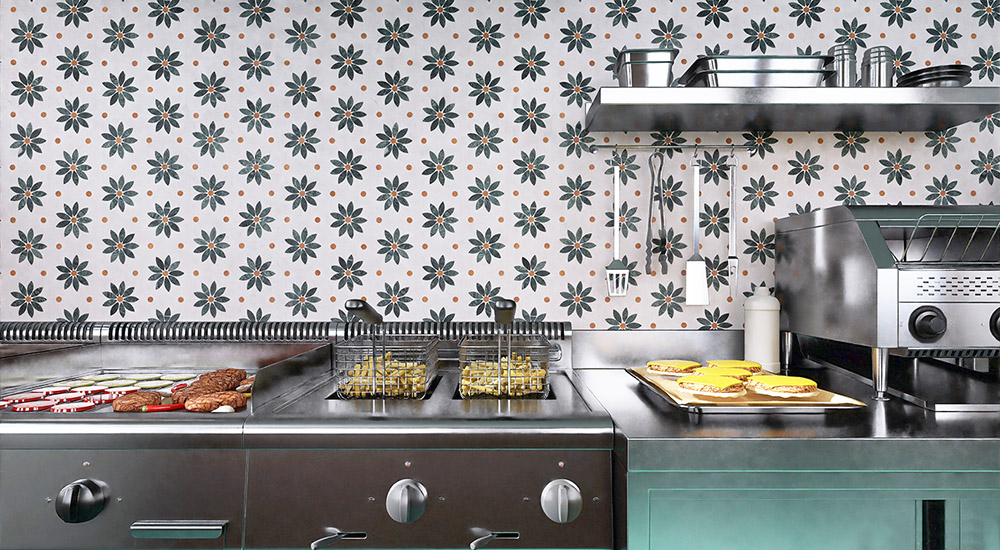{"default":"Wide view of daisy geometric tile backsplash in a stainless steel commercial kitchen"}
