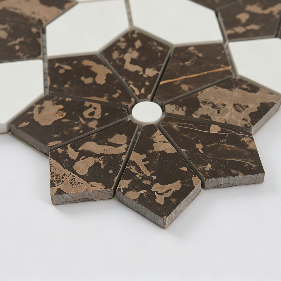Angled close-up of dark brown flower marble mosaic with white octagon accents