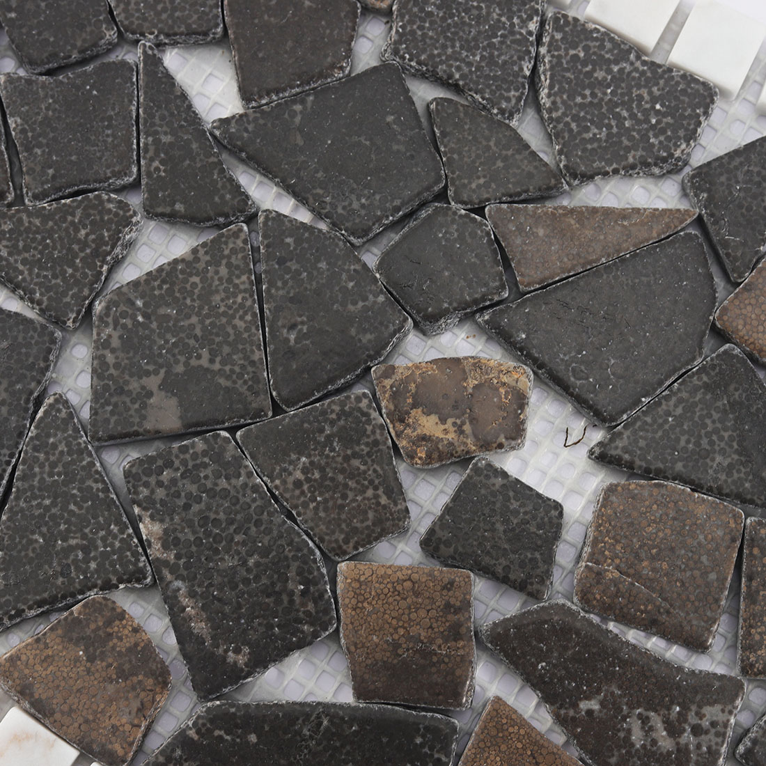 Close up texture of dark brown irregular stone mosaic tile pieces