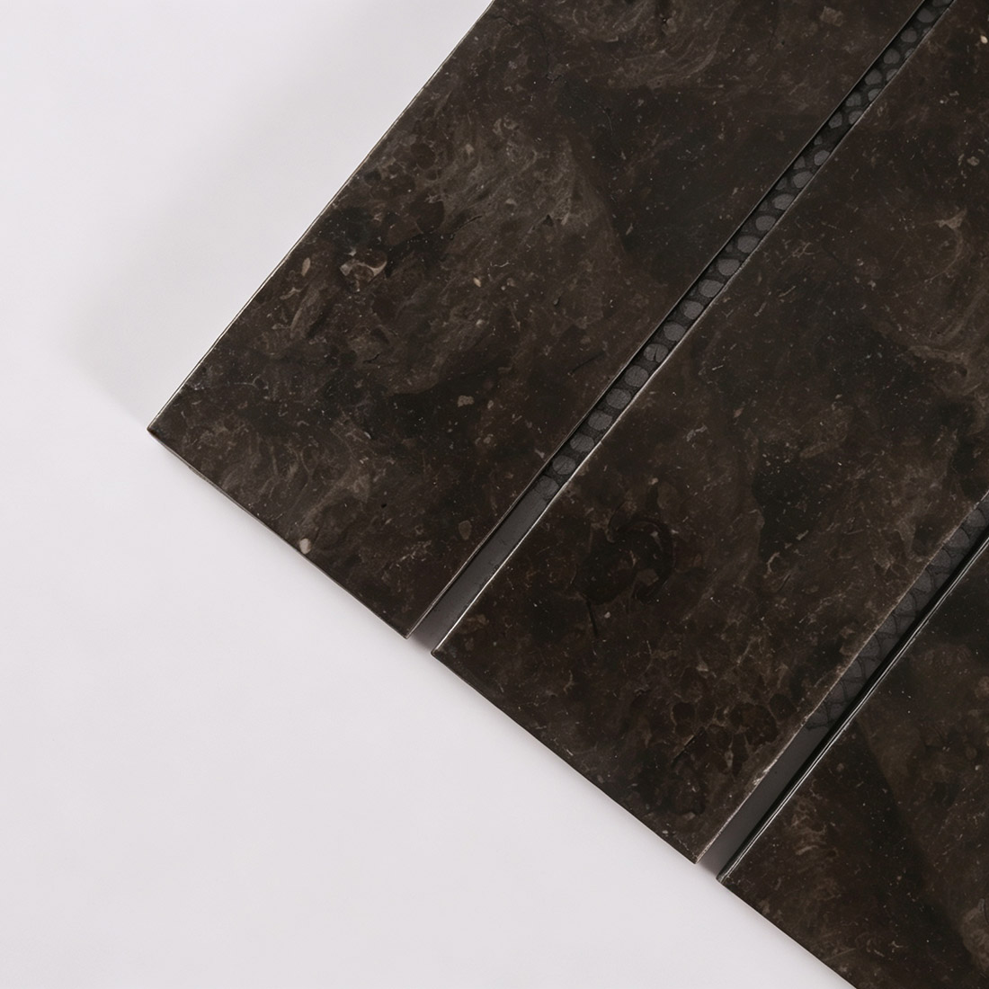 Close-up texture of dark brown marble strip tile with natural veining