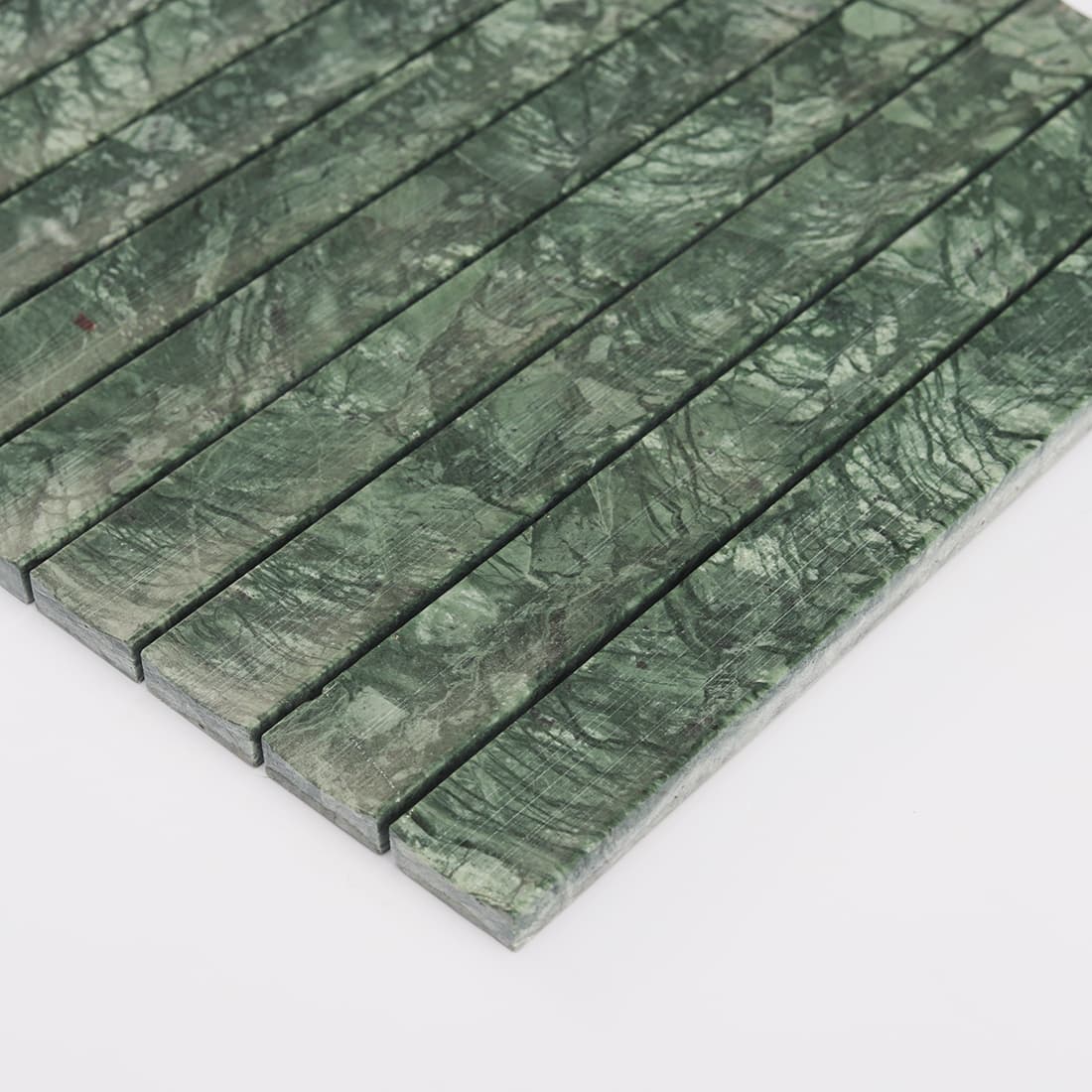 Close up of dark green marble fluted strip mosaic tile