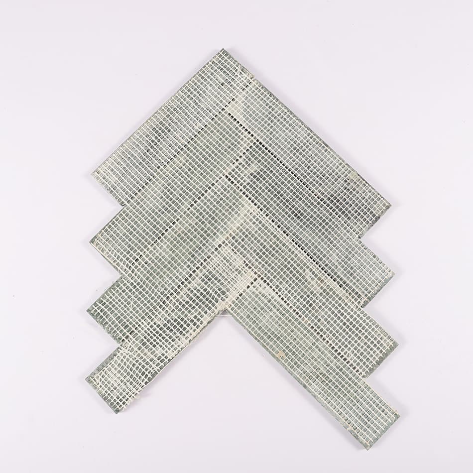 Back view of dark green marble herringbone mosaic tile with mesh backing