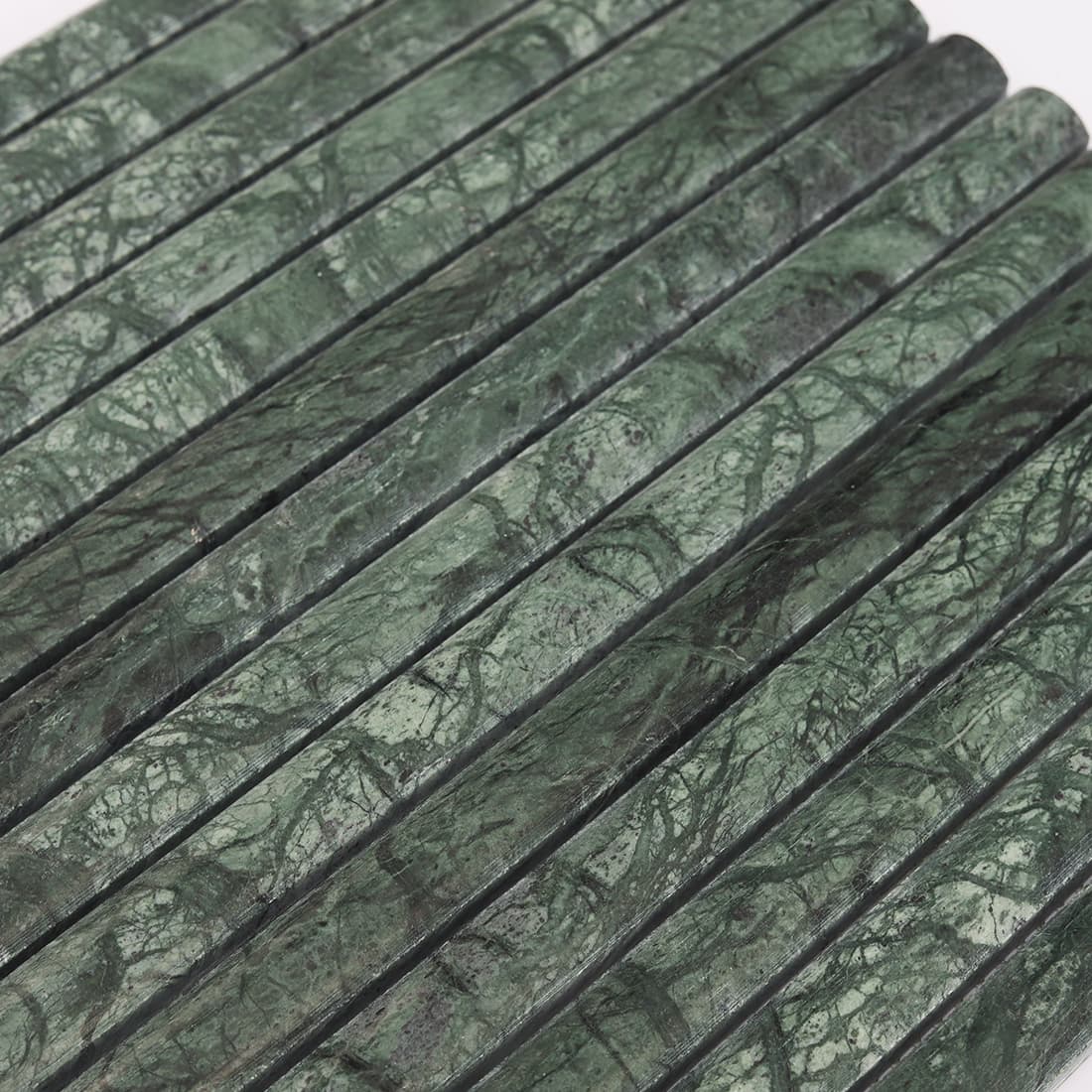 Close-up of dark green marble rounded strip mosaic tile surface