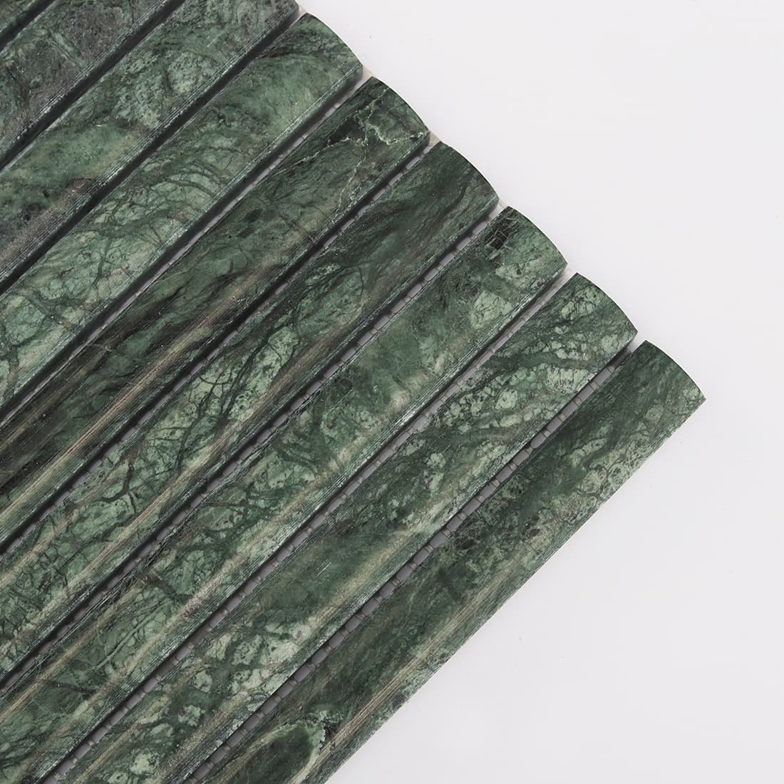 Corner detail of dark green marble rounded strip mosaic tile