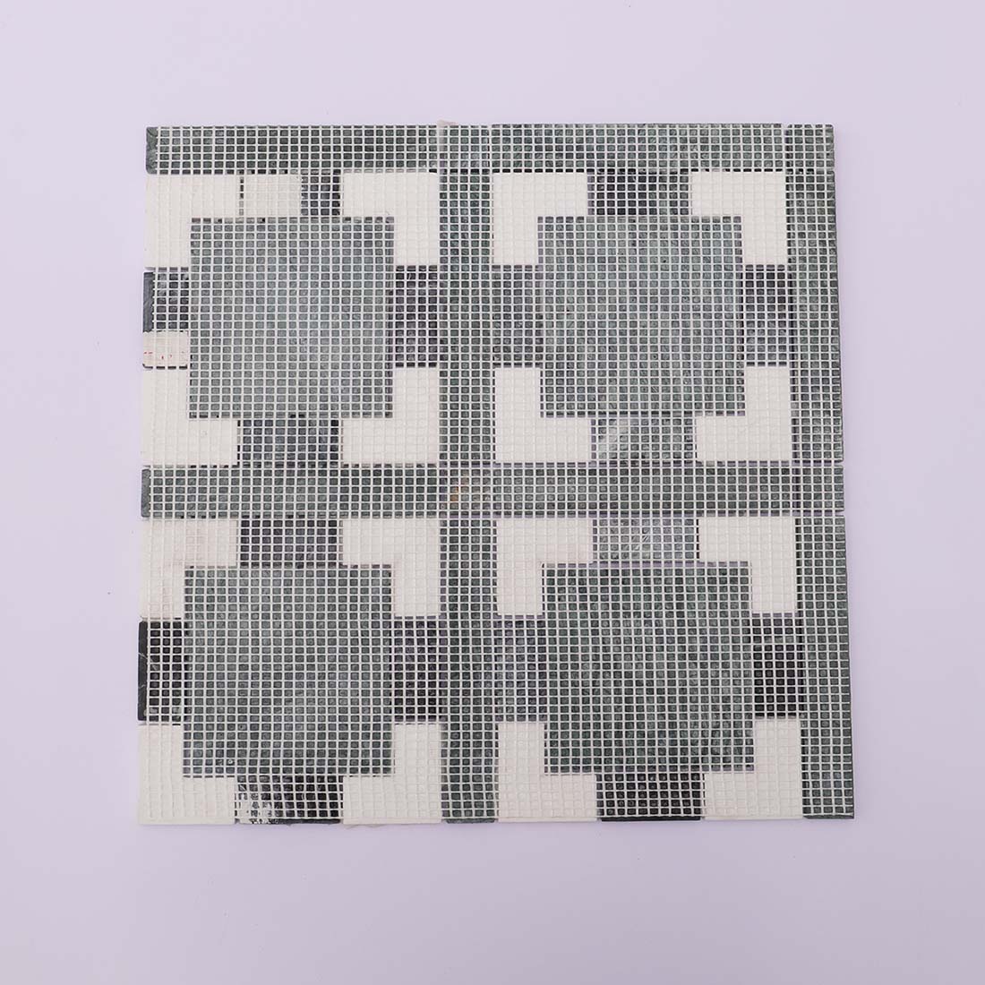 Back view of dark green and white marble mosaic tile with mesh backing.