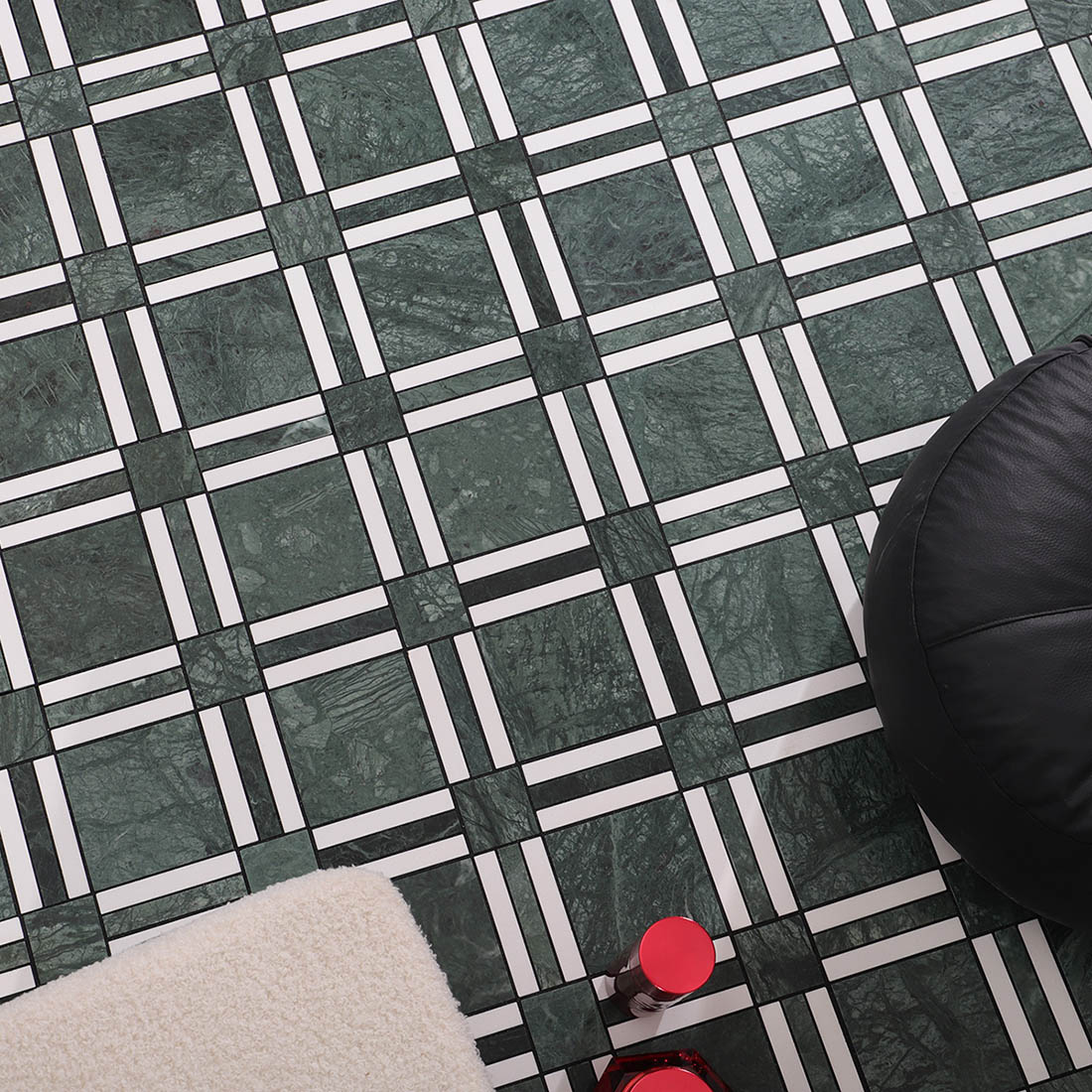 Dark green and white geometric marble mosaic floor tile lifestyle close-up.