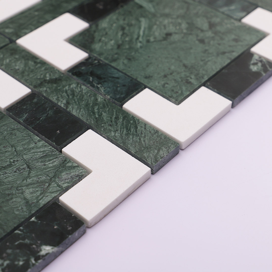 Side view of dark green and white marble mosaic tile showing thickness.