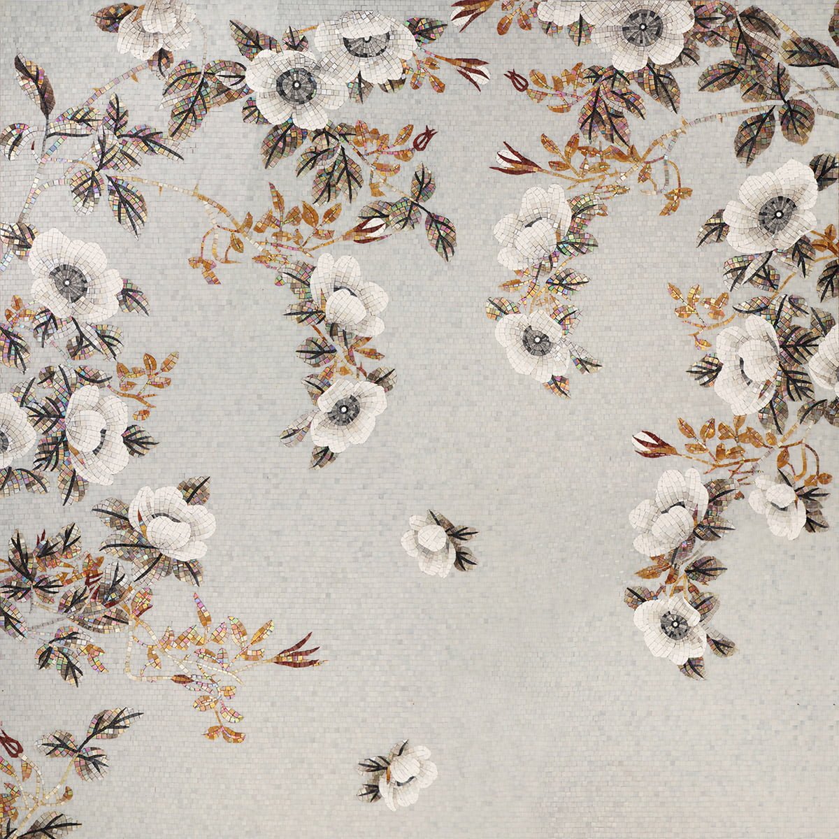 Decorative glass mosaic panel with white floral patterns and golden branches.