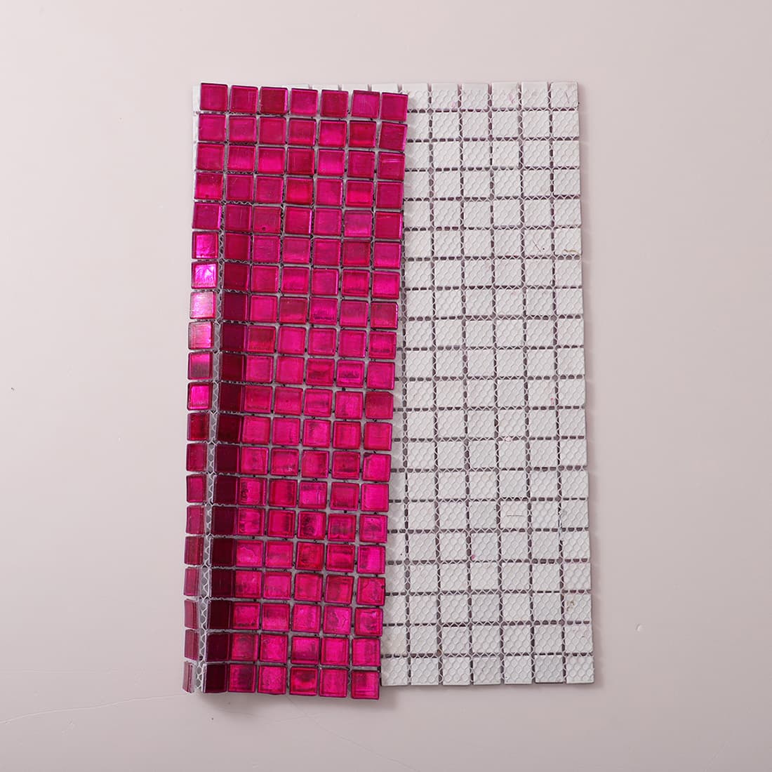 Mesh backing view of deep hot pink foil glass mosaic tile sheet
