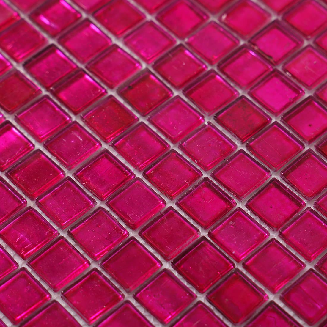 Surface detail of deep hot pink foil square glass mosaic tile
