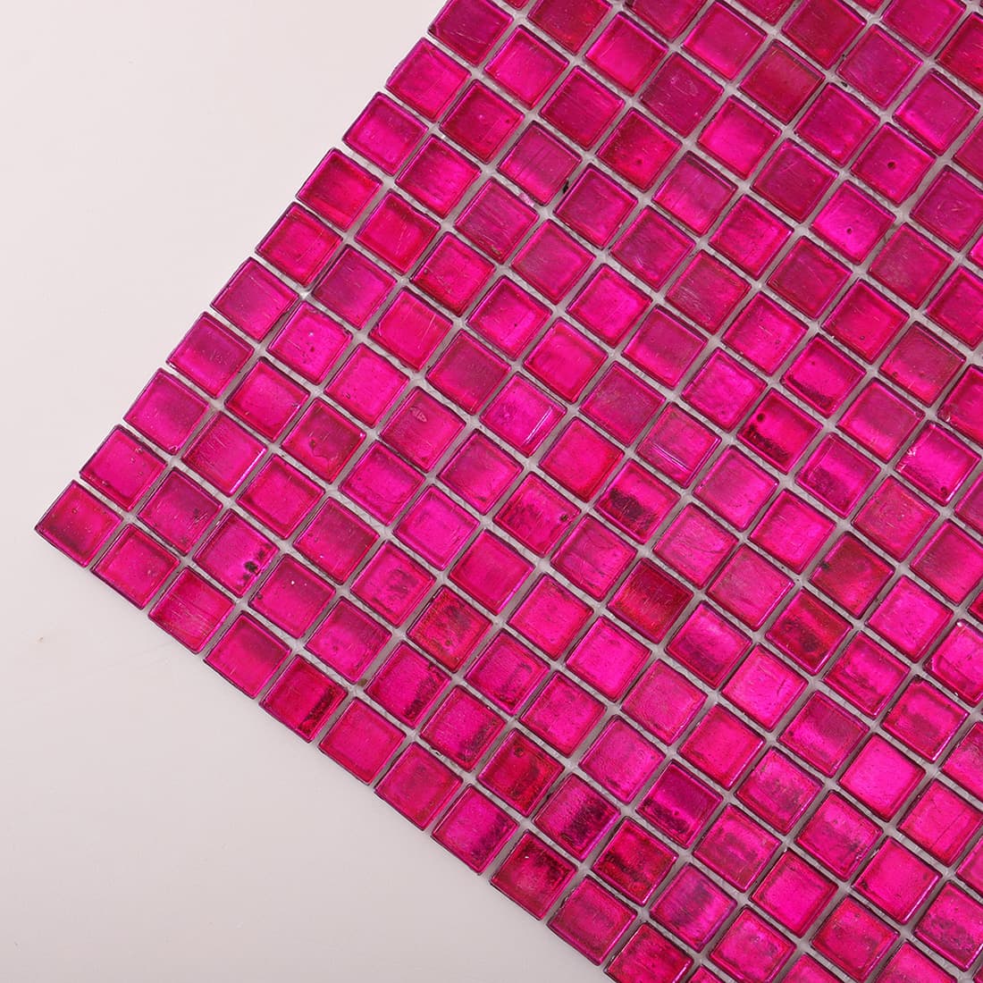 Corner close-up of deep hot pink foil square glass mosaic