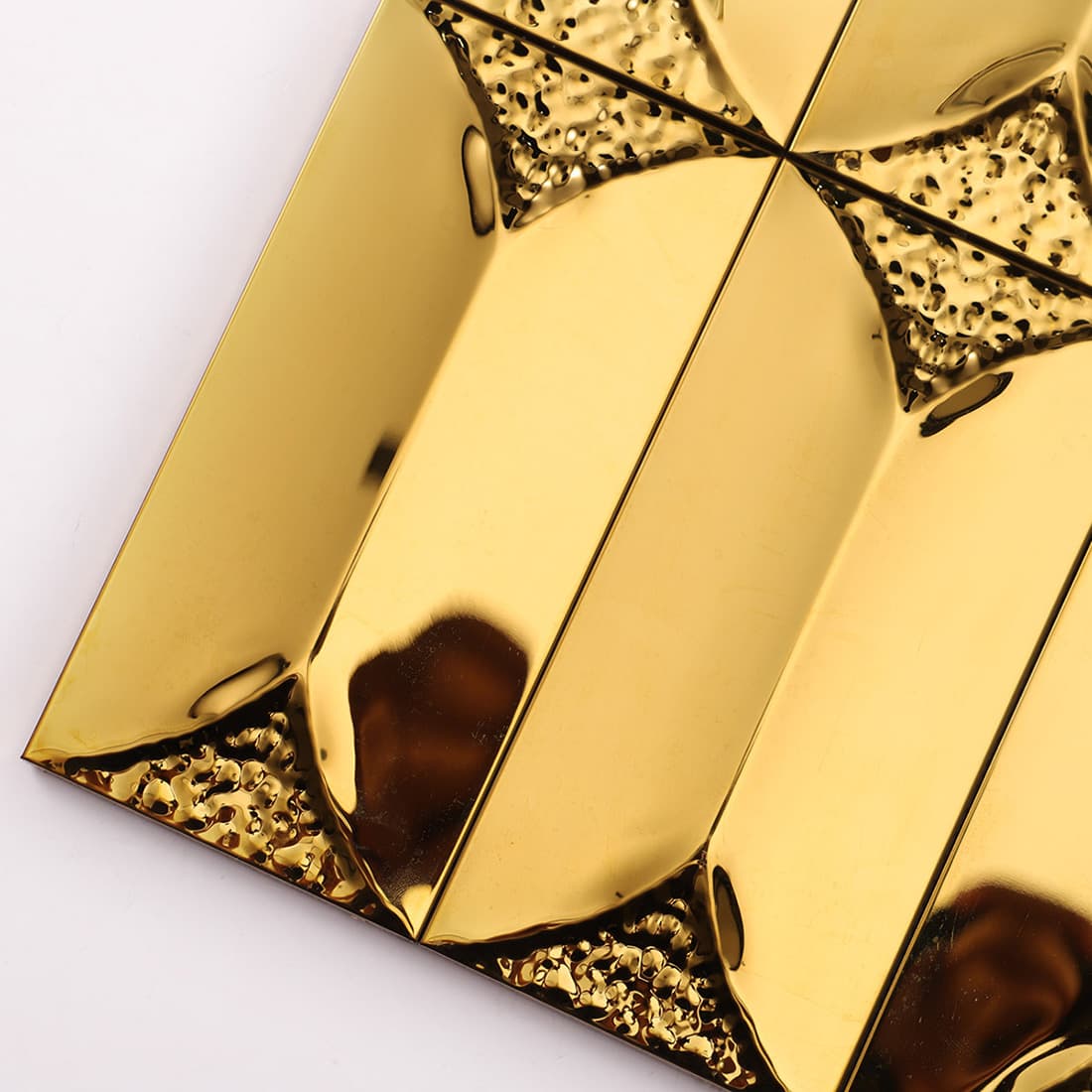 Detailed view of 3D gold metal tiles with hammered textured accents.