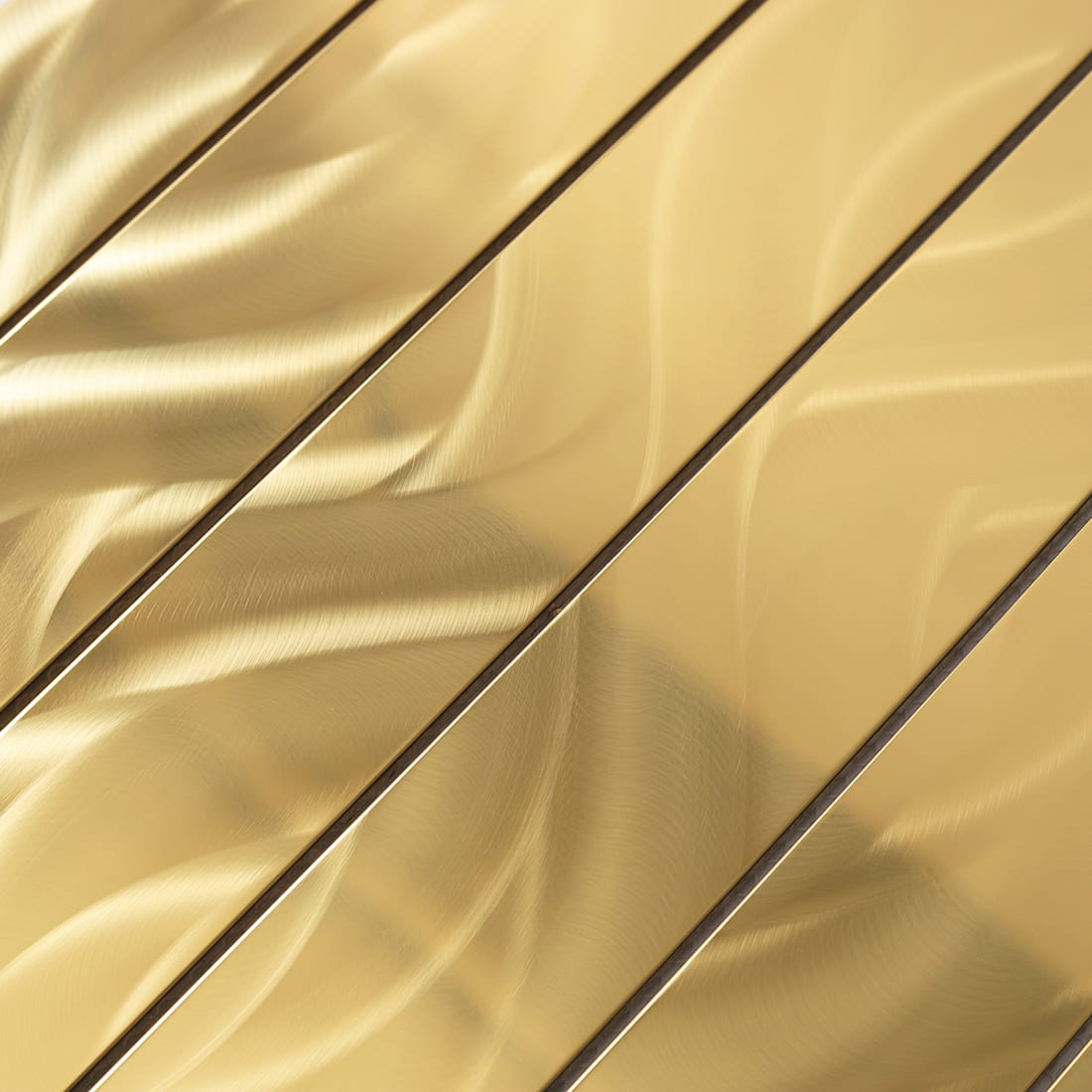 Detailed shot showing the unique swirly brushed grain on gold metal tiles.