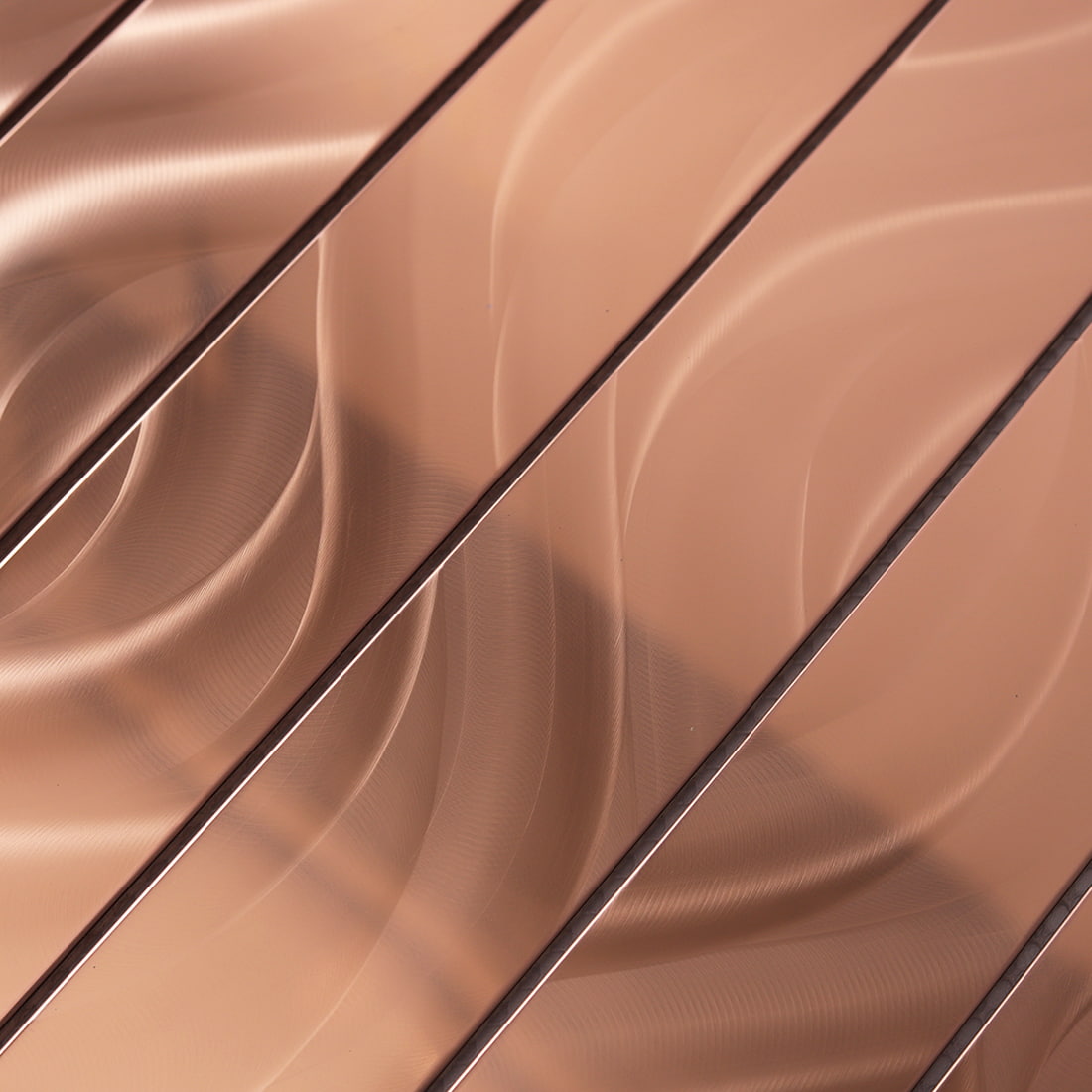 Detailed shot showing the unique flowy brushed grain on rose gold metal tiles.