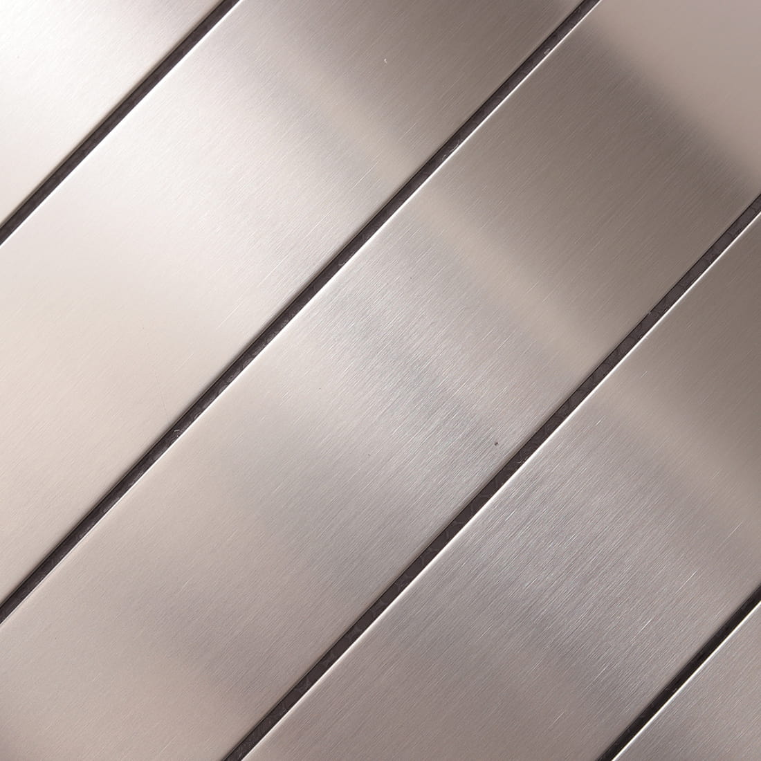 Detailed macro shot of the brushed grain on silver stainless steel strips.
