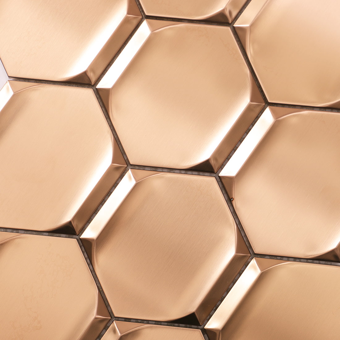 Detailed view of rose gold brushed hexagon metal mosaic tile pattern
