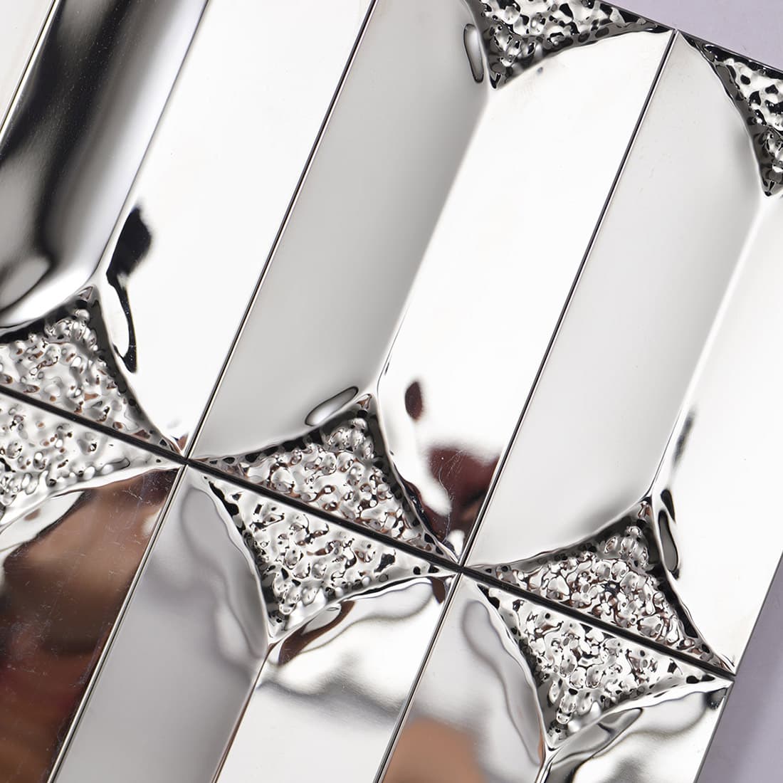 Detailed view showing hammered texture accents on silver 3D metal tiles