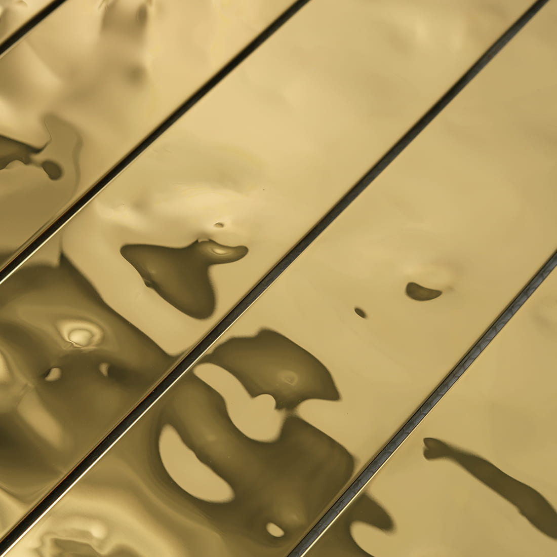Detailed macro shot of the gold water ripple texture on metal tile.