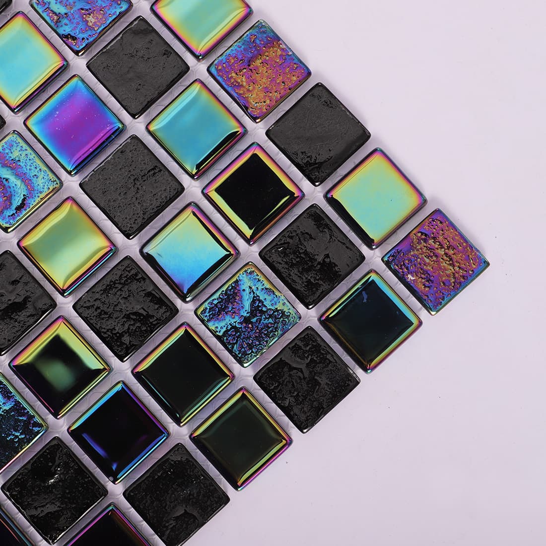 Diagonal perspective of black and iridescent glass stone mosaic tiles.