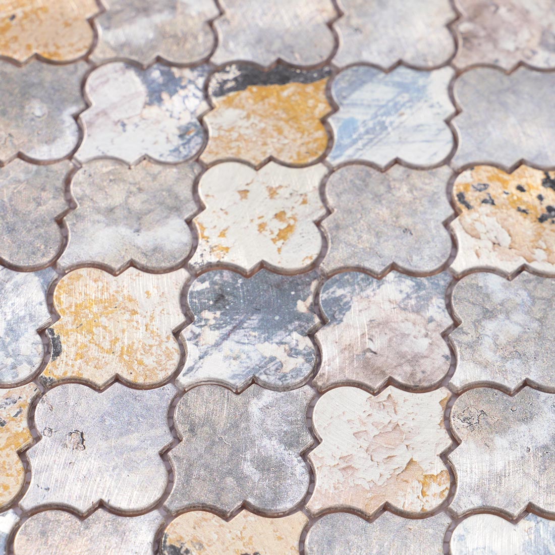 High angle view of distressed arabesque aluminum mosaic tile surface texture