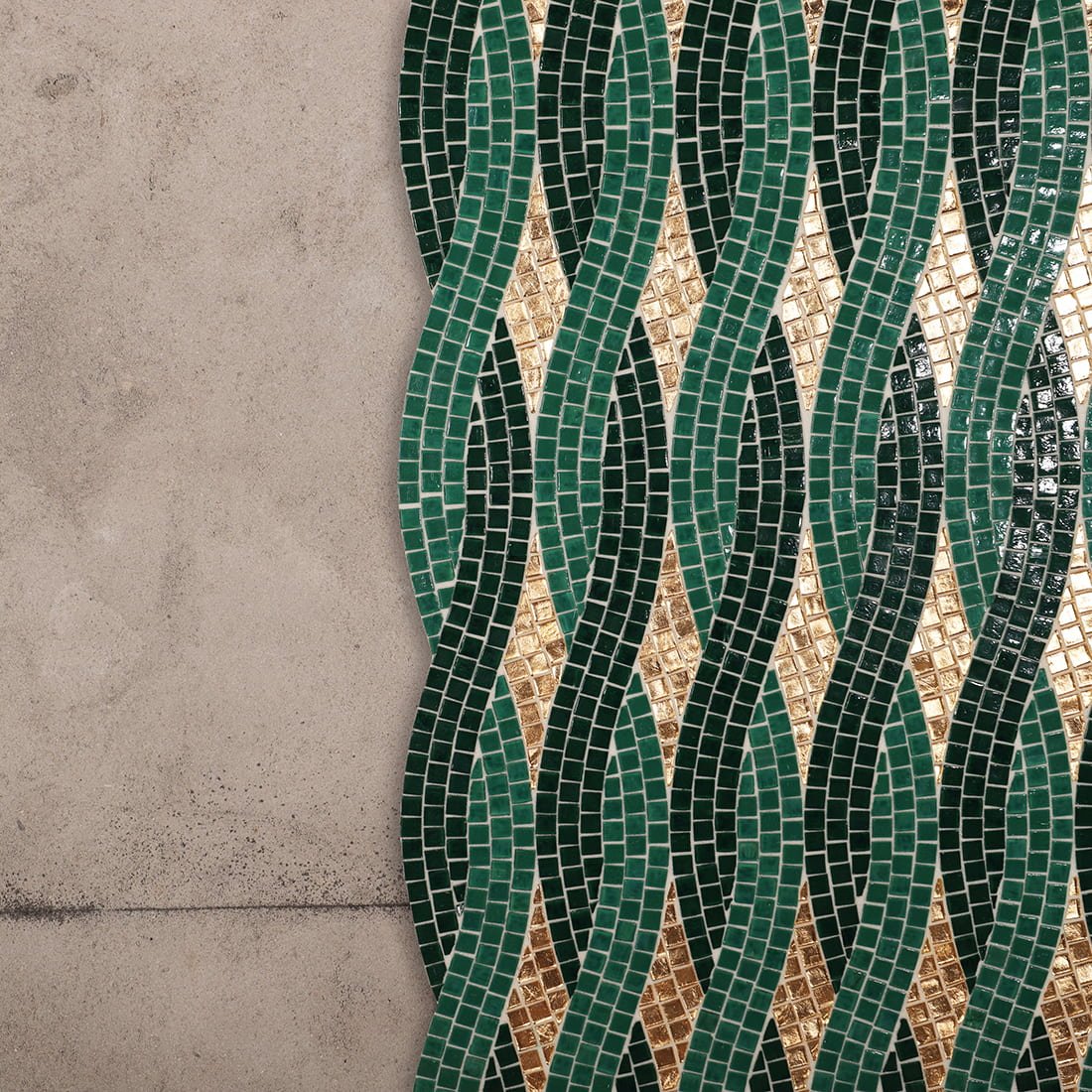 Emerald green and gold wavy pattern glass mosaic tile installed on wall surface.