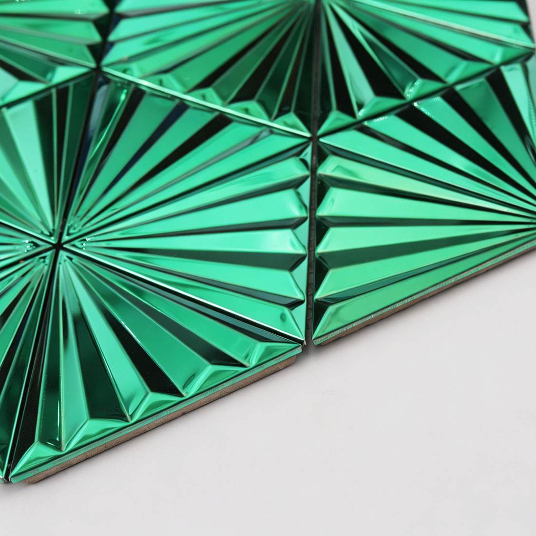 Low angle detail of emerald green fan triangle metal mosaic beveled edge