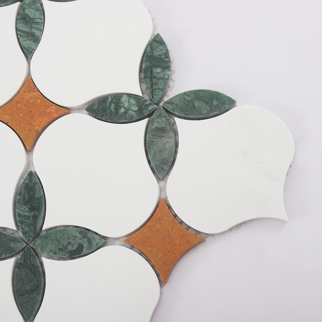 Detailed view of emerald marble leaves, ivory petals, and terracotta stone inlays
