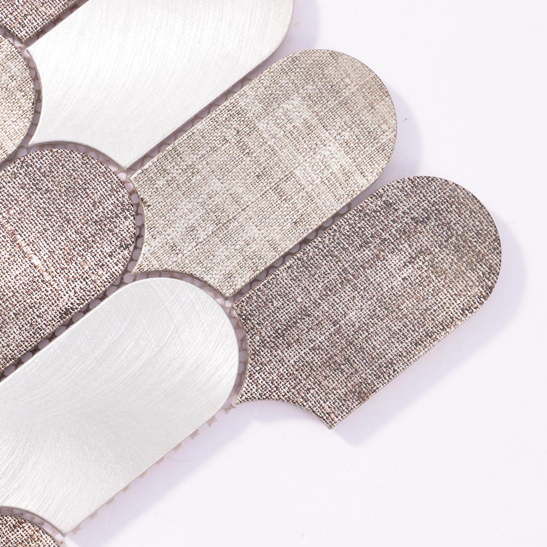 Close-up detail of fish scale arched aluminum mosaic tile with linen texture