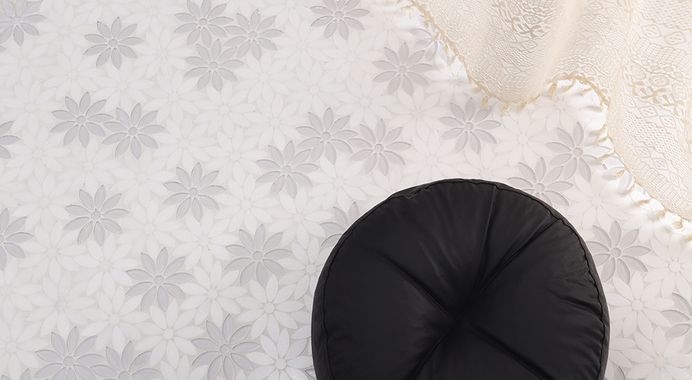 {"default":"White and gray floral mosaic tiles with soft flower pattern on a decorative floor surface"}
