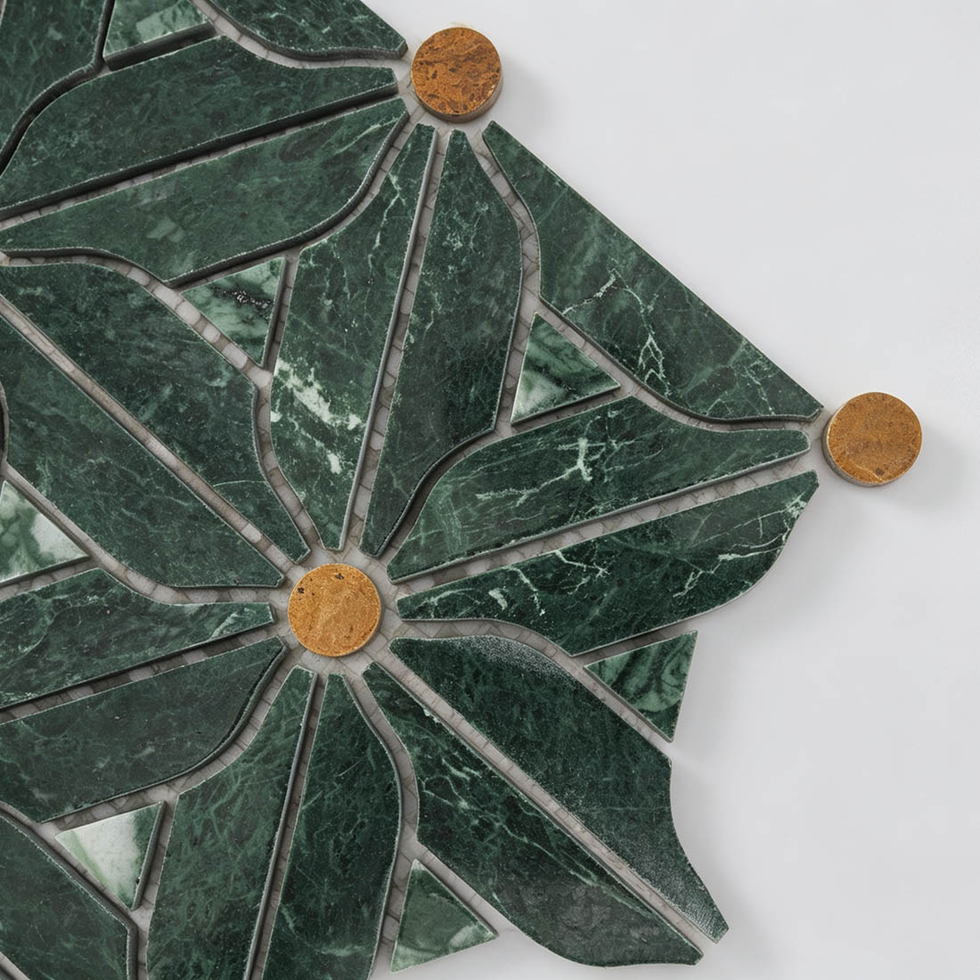 Close-up of forest green marble petals with golden brown round stone inlays