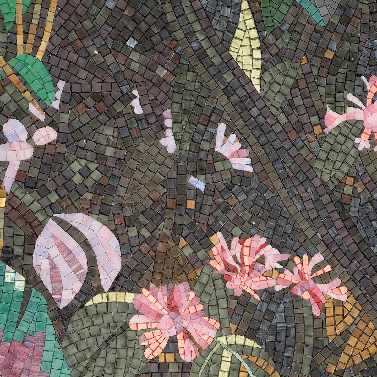 Close-up of a mosaic mural with pink tropical flowers and green leaves arranged in an intricate pattern.